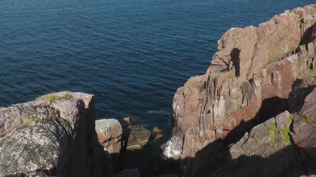 Wild landscape - high cliffs over dark blue North Sea sunny summer day.