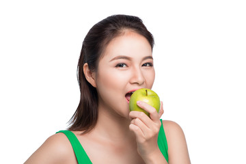 Young beautiful asian woman eating fresh green apple on white background