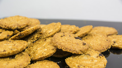 Cookies or biscuits on black neutral surface in studio shot