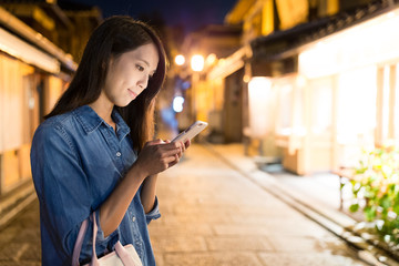 Young Woman using cellphone at night