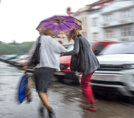 Obraz premium People walking on the street in a rainy day
