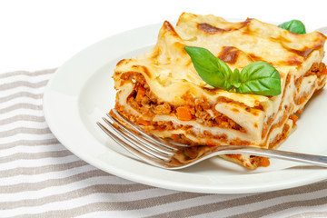 Portion of tasty lasagna isolated on white