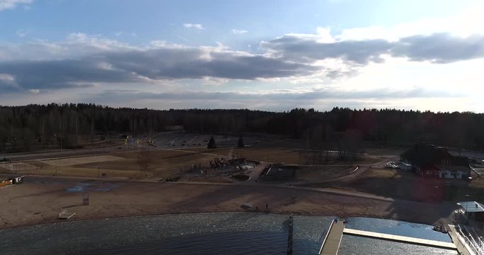 Oittaa, Cinema 4k aerial sideway view of Oittaa beach, at bodom lake, on a sunny spring day, in Espoo, Finland