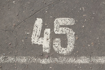 Number 45, forty five, painted on asphalt, running track