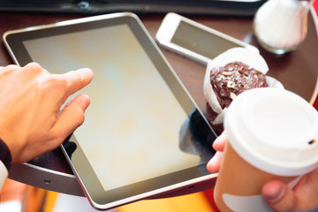 Businessman Sitting In A Cafe, Working On His Tablet