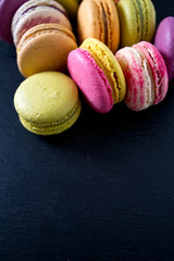 assorted macaroons on black chalkboard