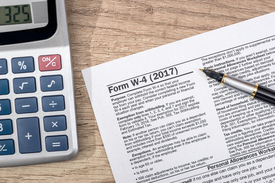 W 4 Tax Form With Pen On Desk.