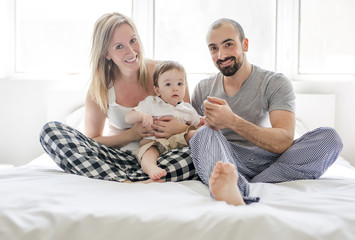 Faces of the Happy and fun family lying in bed