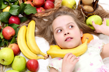 Fototapeta na wymiar exotic fruit or summer background with small surprised girl