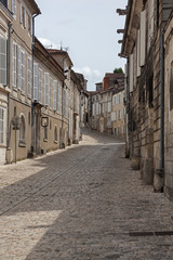 Fototapeta na wymiar Old paved street with facades of old buildings in the famous town Cognac, France