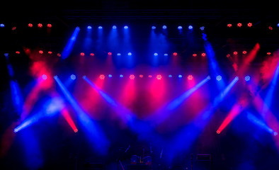 Fototapeta na wymiar Stage light with colored spotlights and smoke.