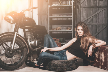 Fototapeta na wymiar girl lying in dirty rubber tire on floor