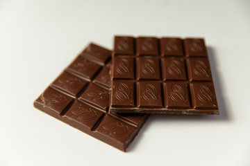 Chocolate pieces on a white background