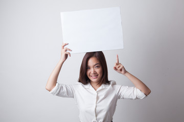 Young Asian woman point to blank sign.