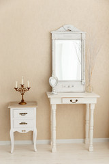 A old retro white dressing table, glass mirror.