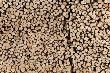 wall firewood , Background of dry chopped firewood logs in a pile