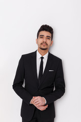 Young businessman in black suit on a white background