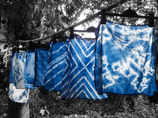 Beautiful natural indigo tie dye fabric with black and white background.