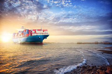 Logistics import export background of Container Cargo ship in the ocean st sunset sky, Freight...