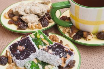 Tea, nuts, raisins, sweets
