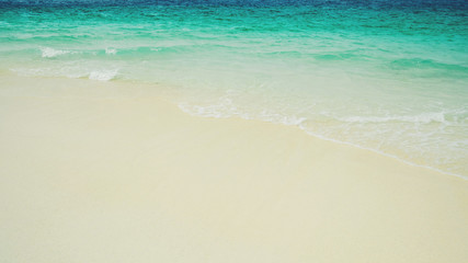 Soft wave of blue ocean on sandy beach