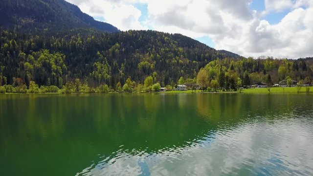 Aerial view of lake thiersee tirol Austria in 4K - flying above water surface