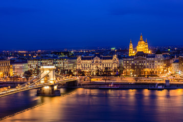 Fototapeta premium Aerial view of Budapest at night. Hungarian landmarks: Chain Bridge, St. Istvan's Basilica and Danube river in Budapest.