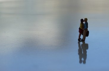 romantic silhouette of kissing couple on isolated background. Intentional soft focus to give the idea of realism (es: real couple on an icy lake). Miniature people.