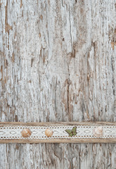 Shabby chic background with seashells and lace fabric on old wood