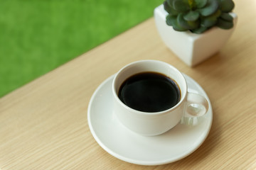 Coffee in white cup on wood table