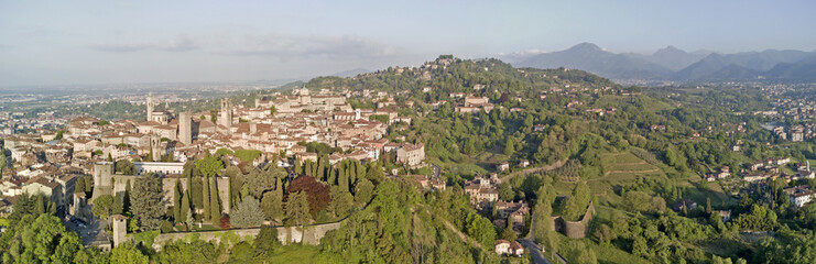 Fototapeta na wymiar Drone aerial view of Bergamo - Old city (upper town), Italy. Landscape on the city center, the old fortress and its historical buildings during a wonderful blu day