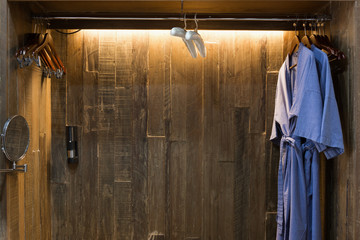 Obraz na płótnie Canvas Blue twin bathrobe in wooden wardrobe of luxury hotel