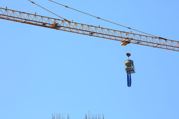 construction crane hoisting cement bucket mixer pouring