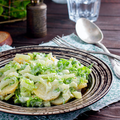 Fresh homemade potato salad with greens, square