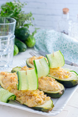 Stuffed halves of courgettes with chicken meat and brown rice, selective focus