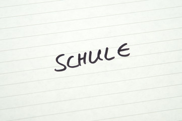 Word Schule (School) in Handwriting on lined paper