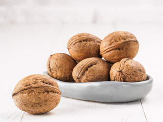inshell walnut on white wooden background