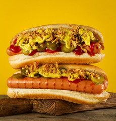 Tasty classic traditional hot dog on wooden board.