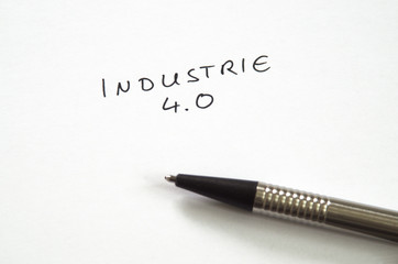 Industrie 4.0 (Industry 4.0) in handwriting on white background with pen