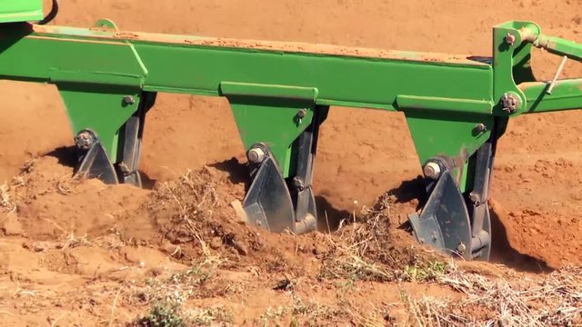Tractor with implement in a field