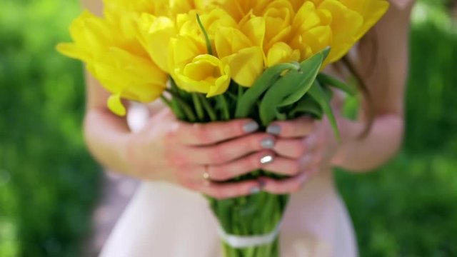 Woman carrying bouquet of tulips