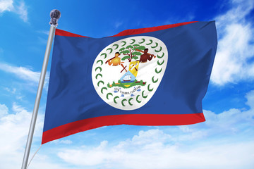 Flag of Belize developing against a clear blue sky