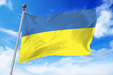 Flag of Ukraine developing against a clear blue sky