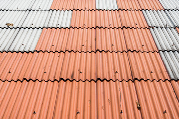 Obraz na płótnie Canvas Orange roof tile and purple background texture. Top view of tile roof orange color.