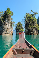 Fototapeta premium Limestone mountain ranges with long-tailed boat at Khao Sok National Park in Surat Thani Province, Thailand