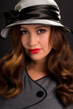Vintage Style Portrait Of Beautiful Young Woman Wearing Hat.