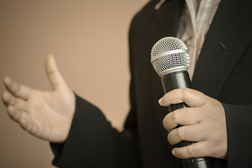 Businesswoman speech with microphone, hand gesturing protesting or belief concept for explaining