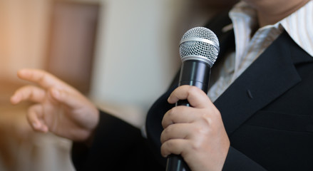 blurred of Businesswoman speech with microphone, hand gesturing protesting or belief concept for...