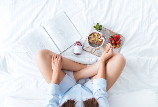 Young Woman Eating Healthy Breakfast In Bed 