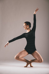 Fototapeta premium Young ballerina having exercises in the studio